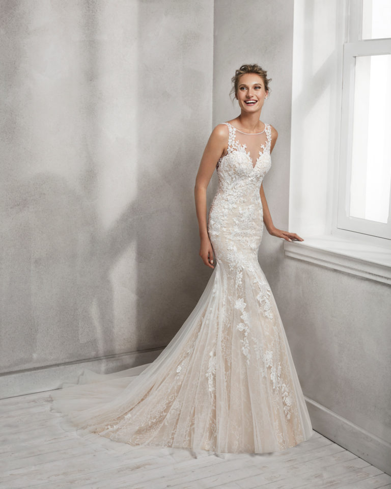 Mermaid-style lace wedding dress with illusion neckline and low back, in nude and natural.