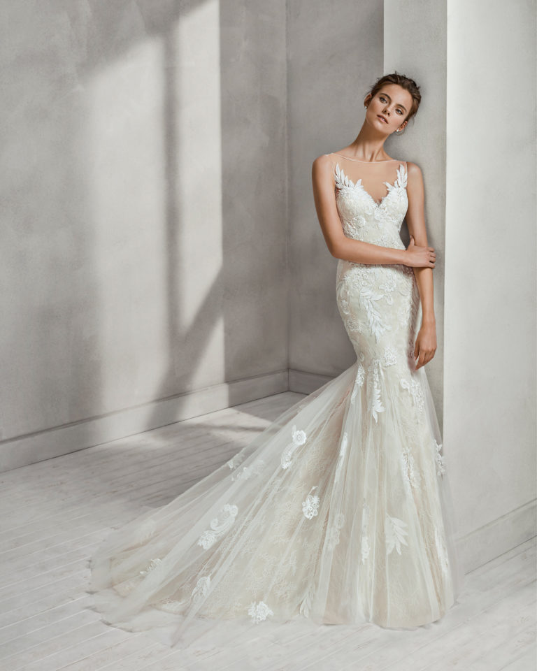 Mermaid-style beaded lace and tulle wedding dress with V-neckline and low back, in nude, and in natural with overskirt.