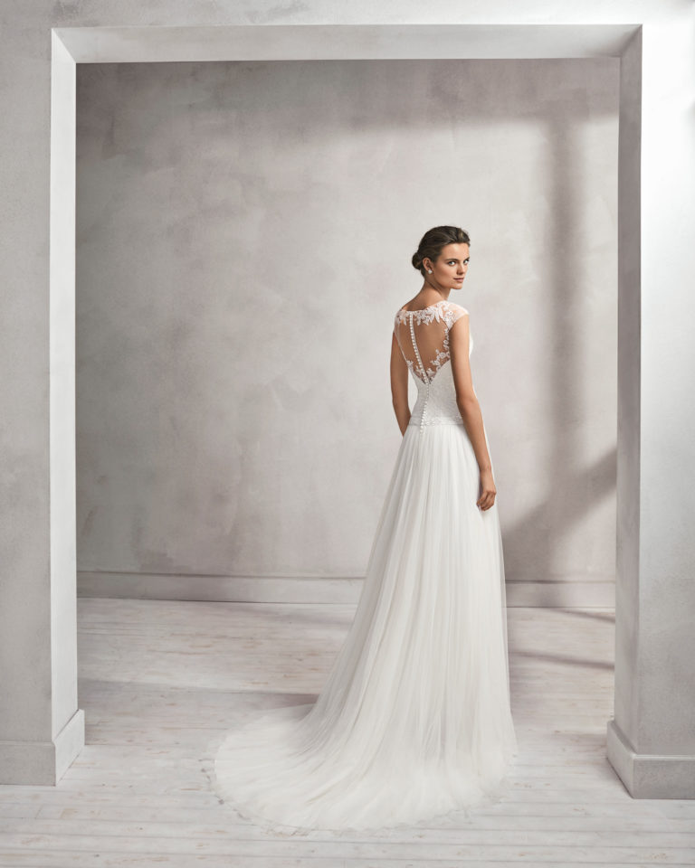 Beaded lace and tulle sheath wedding dress with illusion neckline.