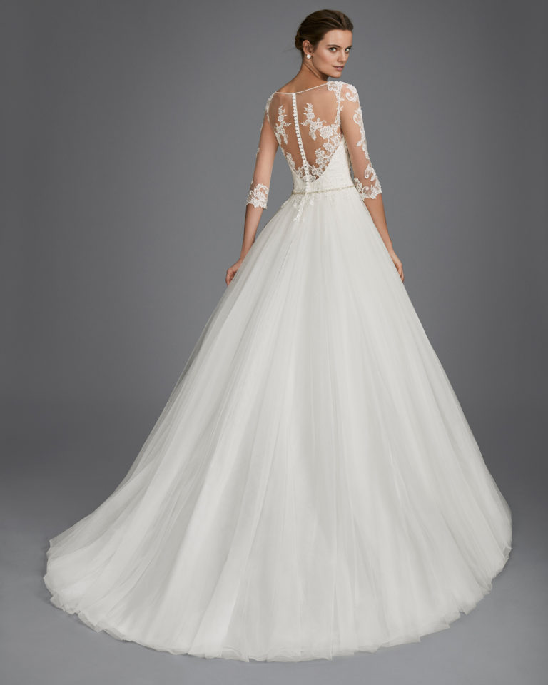 Princess style beaded lace and tulle wedding dress with three-quarter sleeves, V-neckline and low back.