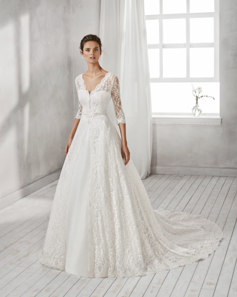 Mermaid-style organza wedding dress with sweetheart neckline and long-sleeved beaded lace jacket.