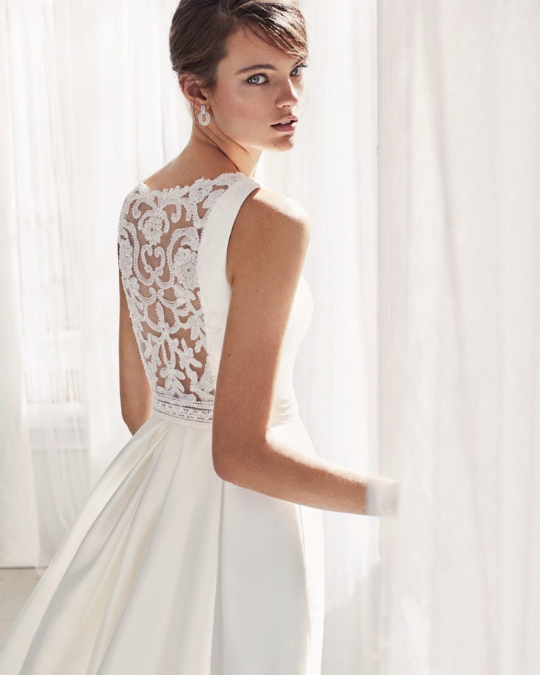 Mermaid-style mikado wedding dress with bateau neckline, beaded back and overskirt.