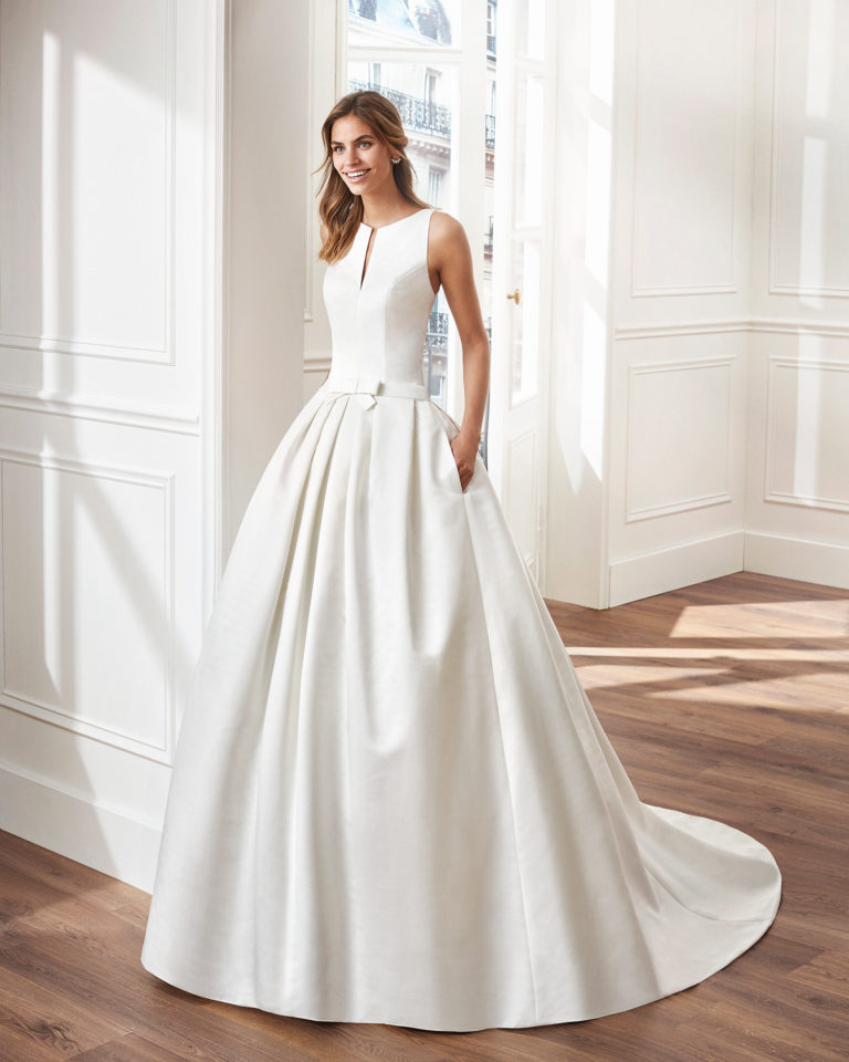 Classic A-line ottoman wedding dress. V-neckline and lace back. Available in natural. 2019  Collection.