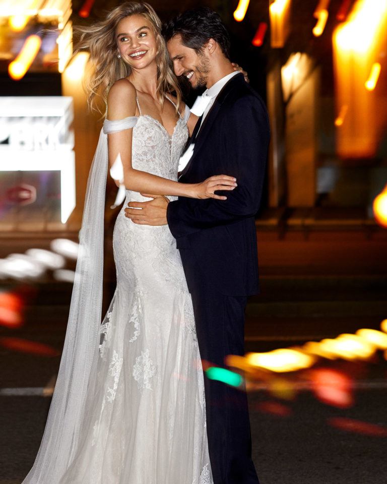 Mermaid-style wedding dress in corded lace and tulle with beaded straps, tulle draping and V-back. 2020 Collection.