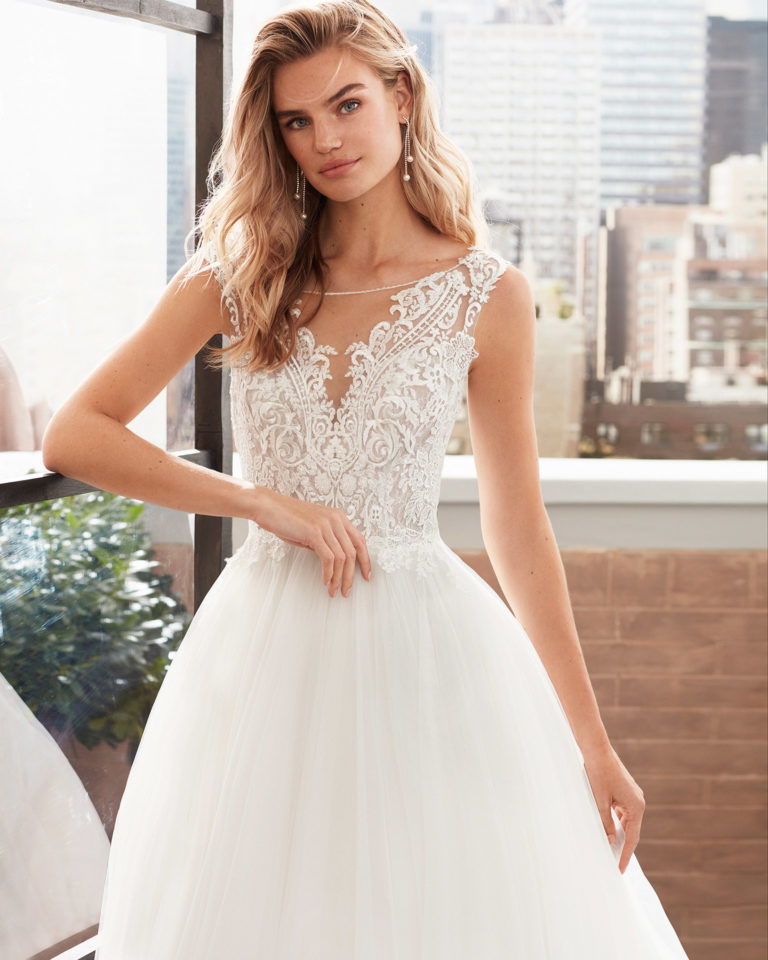 Princess-style tulle and lace wedding dress with beading and neckline and back with sheer inserts. 2020 Collection.