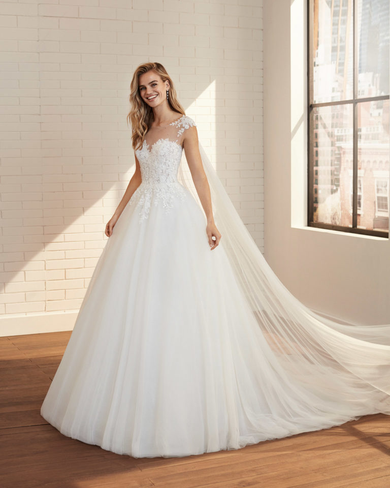 Romantic tulle and lace wedding dress with beading and neckline and back with sheer inserts. 2020 Collection.