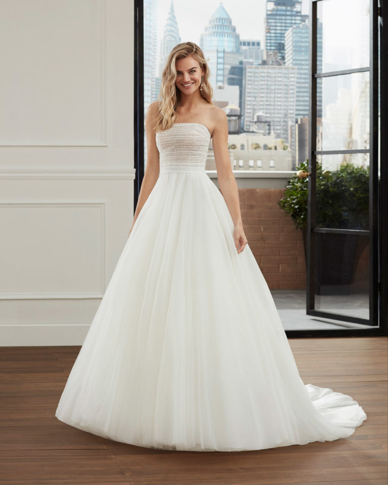 Romantic beaded soft tulle wedding dress with strapless neckline and full skirt. 2020 Collection.