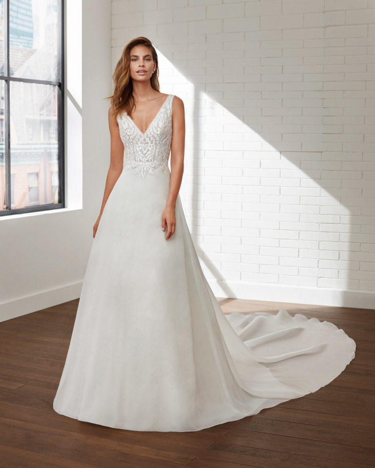 A-line lace and organza wedding dress and train with beading and V-neckline and back. 2020 Collection.