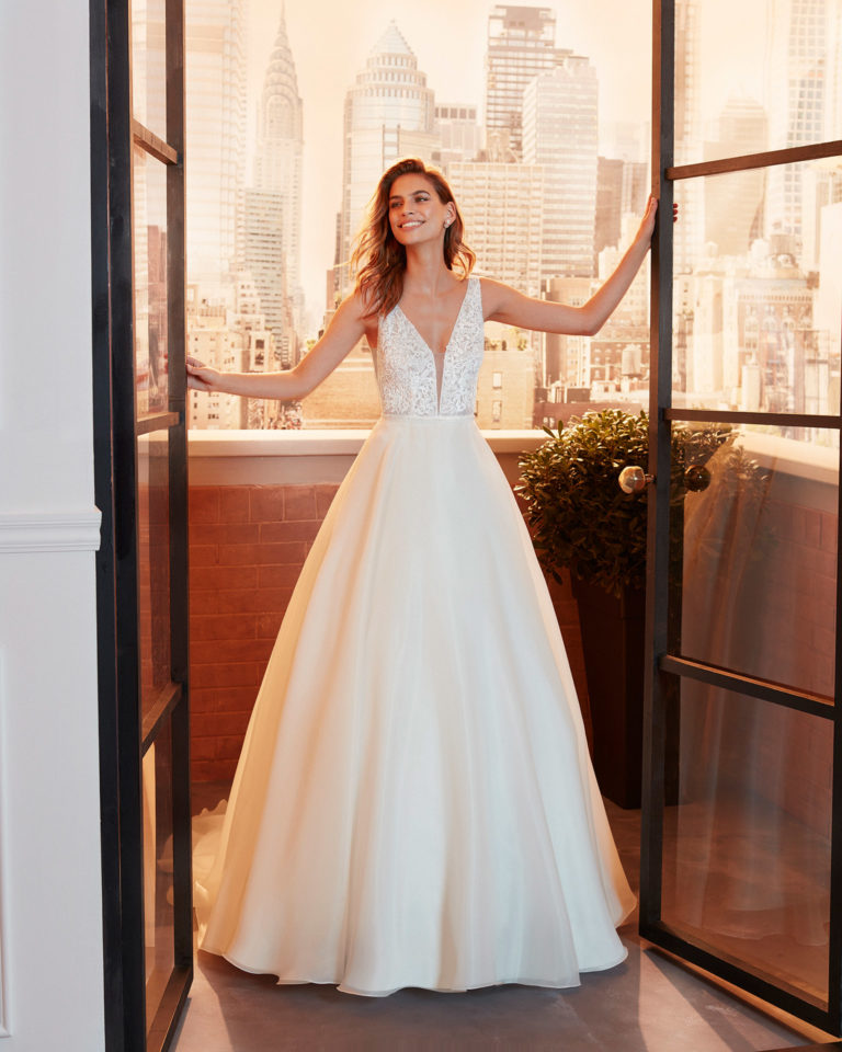 Classic beaded lace wedding dress with deep-plunge neckline and low V-back. 2020 Collection.