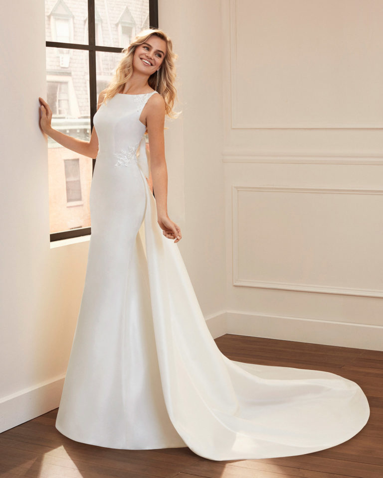 Mermaid-style wedding dress and train in bari and lace with beading, bateau neckline and back with sheer inserts. 2020 Collection.