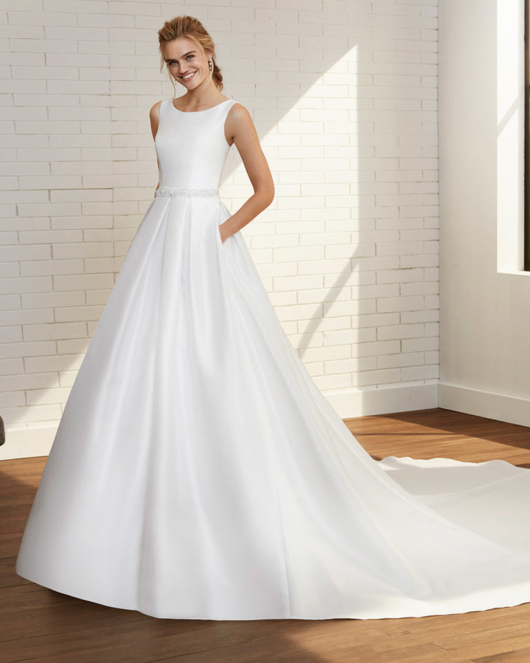 Classic wedding dress in beaded bari with bateau neckline and V-back. 2020 Collection.