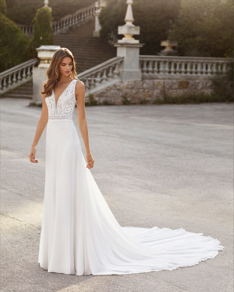 Ballgown-style wedding dress in chiffon and lace. Deep-plunge neckline and V-back. 2021  Collection.