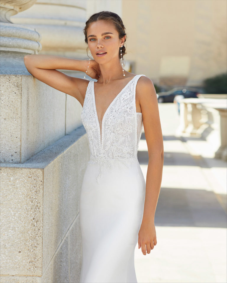 Sheath-style wedding dress in stretch crepe and beaded lace. Deep-plunge neckline and low back. 2021  Collection.