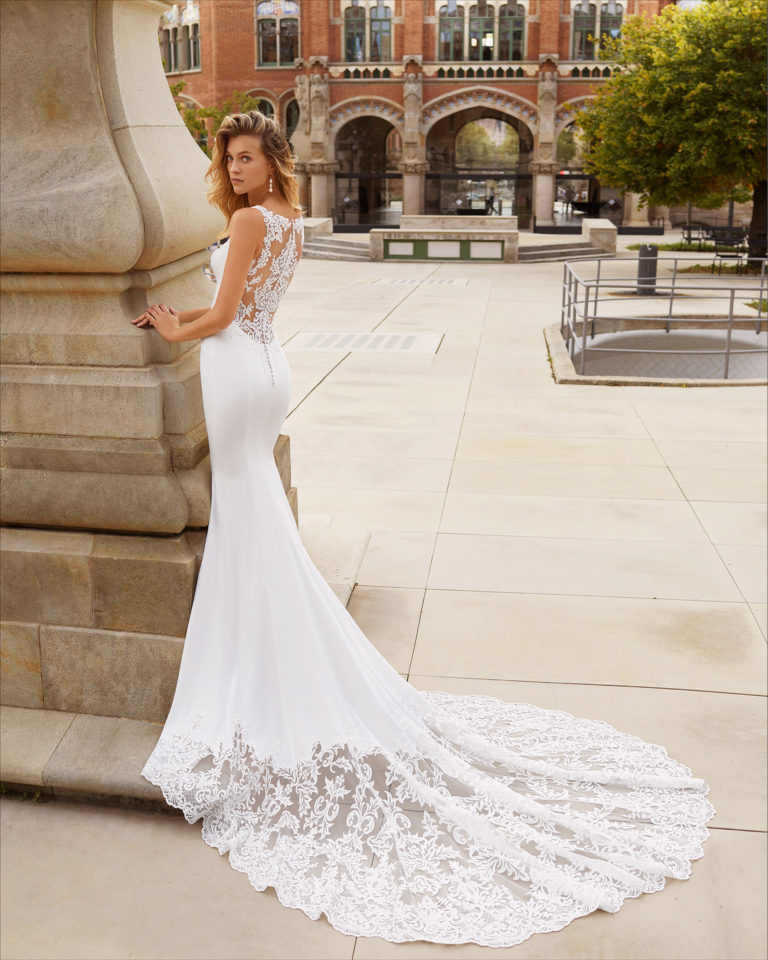 Mermaid-style wedding dress in stretch crepe and lace. V-neckline and sheer back with lace. 2021  Collection.