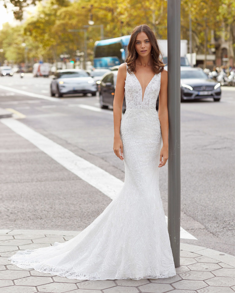 Mermaid-style beaded lace wedding dress. Deep-plunge neckline and V-back. 2021  Collection.