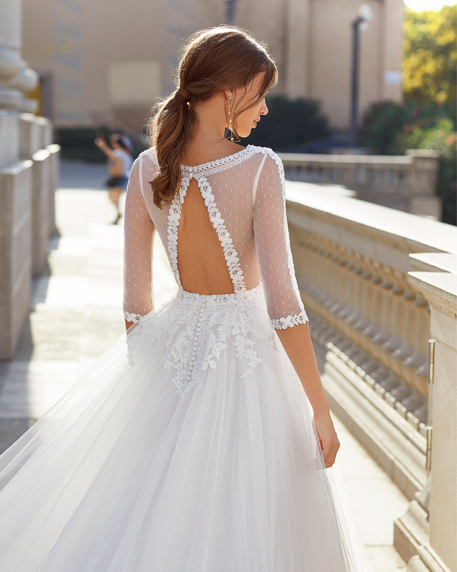 Romantic-style wedding dress in dot tulle and beaded lace. V-neckline, back in dot tulle with opening and three-quarter sleeves. 2021  Collection.