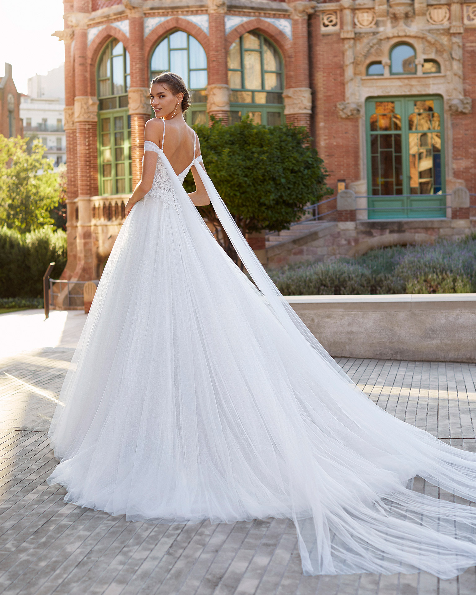 Romantic-style wedding dress and flaps in dot tulle and beaded lace. Bardot neckline, spaghetti shoulder straps and tulle flaps. 2021  Collection.