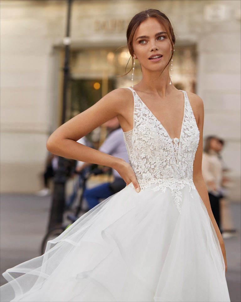 Ballgown-style wedding dress in tulle and beaded lace. With V-neckline and low back. 2021 Collection.