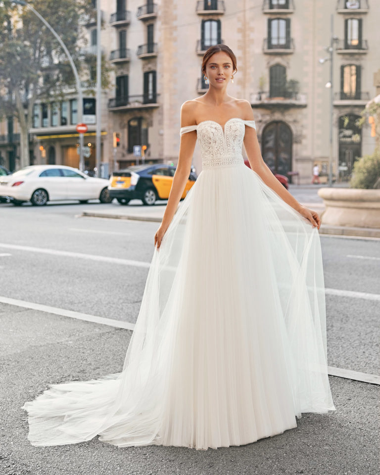 Sheath-style wedding dress in soft tulle and beaded lace. Sweetheart neckline with off-the-shoulder straps. 2021  Collection.