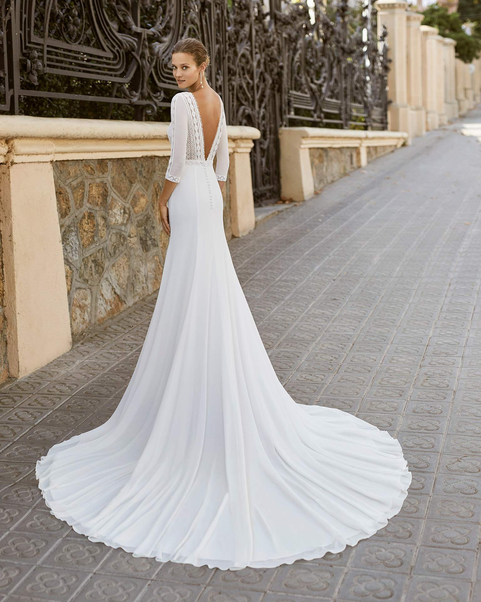 Lightweight wedding dress in georgette with beaded waist. Boat neck, low back and 3/4-length sleeves. 2022  Collection.