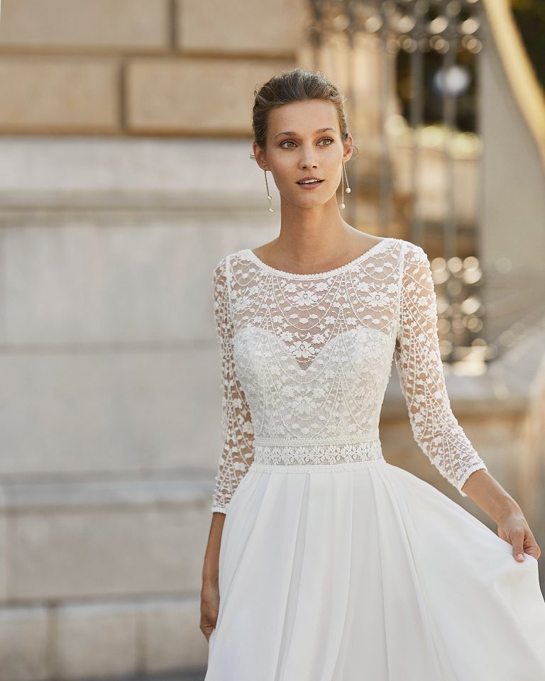 Lightweight wedding dress in georgette and beaded lace. Boat neck, V-back and 3/4-length sleeves. 2022 Collection.