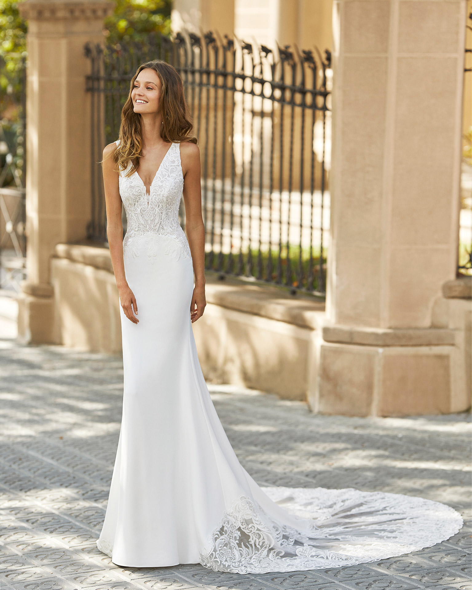 Sheath wedding dress in stretch crepe with shaping lining and lace. Deep-plunge neckline and low back. 2022  Collection.