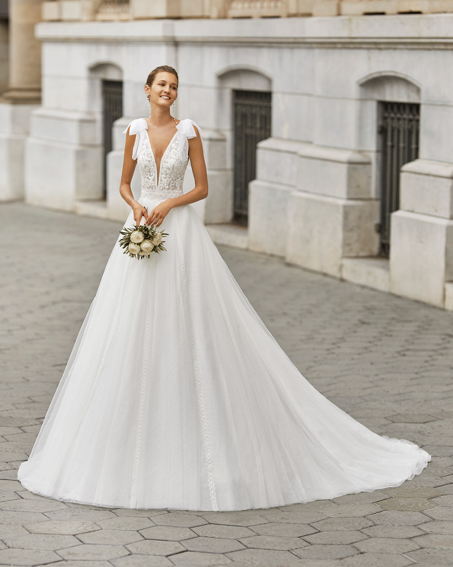Romantic wedding dress, dot tulle, lace and beaded neckline and waist. Deep-plunge neckline, V-back and dot tulle bows on the shoulders. 2022  Collection.