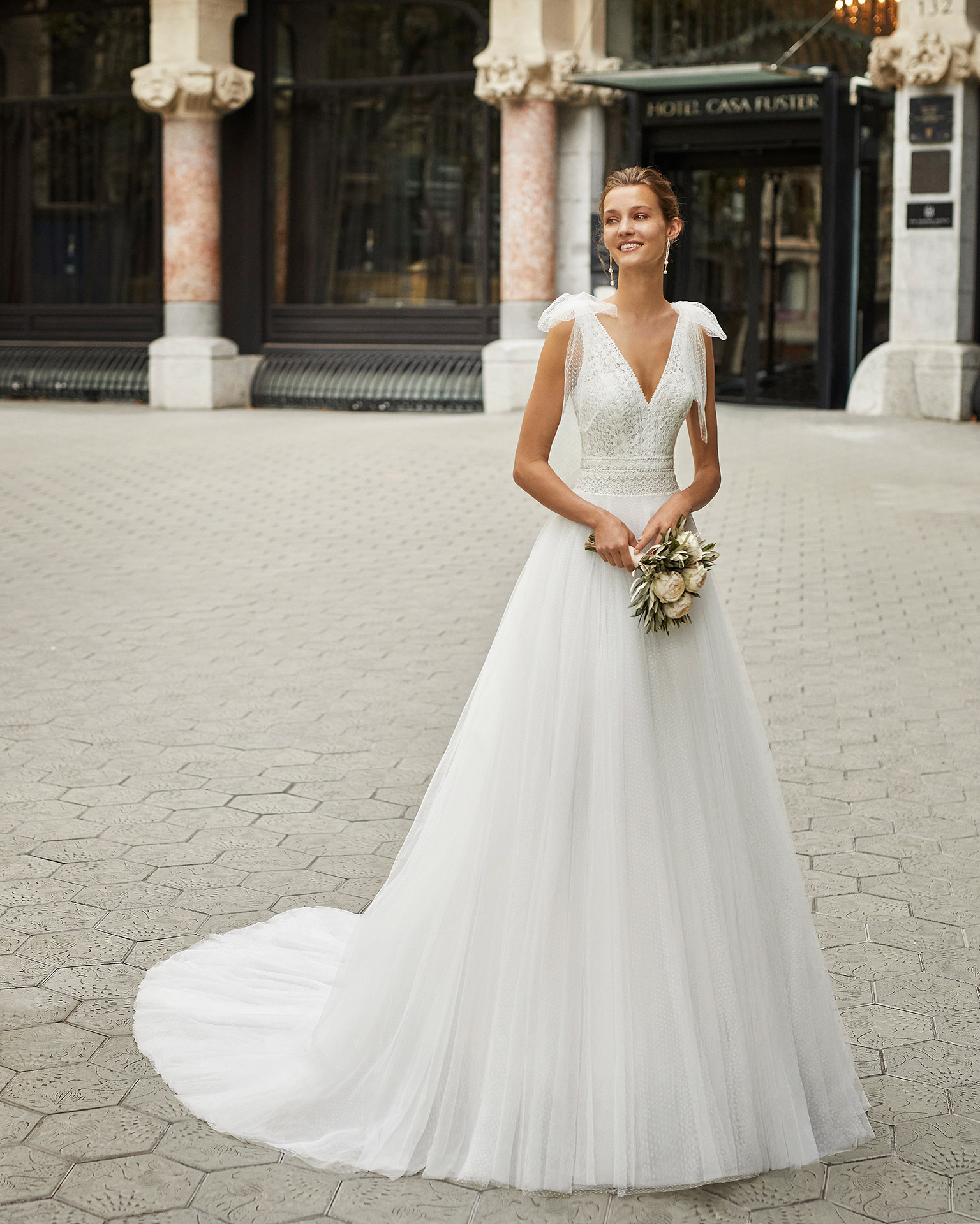 Romantic wedding dress, dot tulle, lace and beaded neckline, back, armholes and waist. V-neck, low back and dot tulle bows on the shoulders. 2022  Collection.