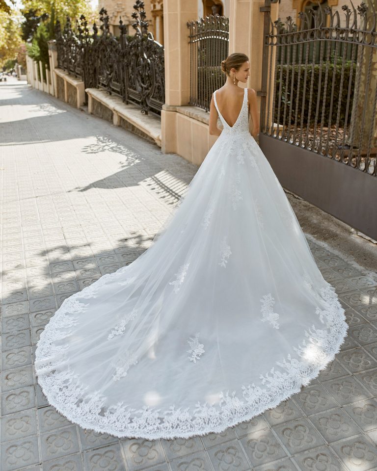 A line wedding dress, tulle, lace and beaded neckline and armholes. Deep-plunge neckline and V-back. 2022 Collection.