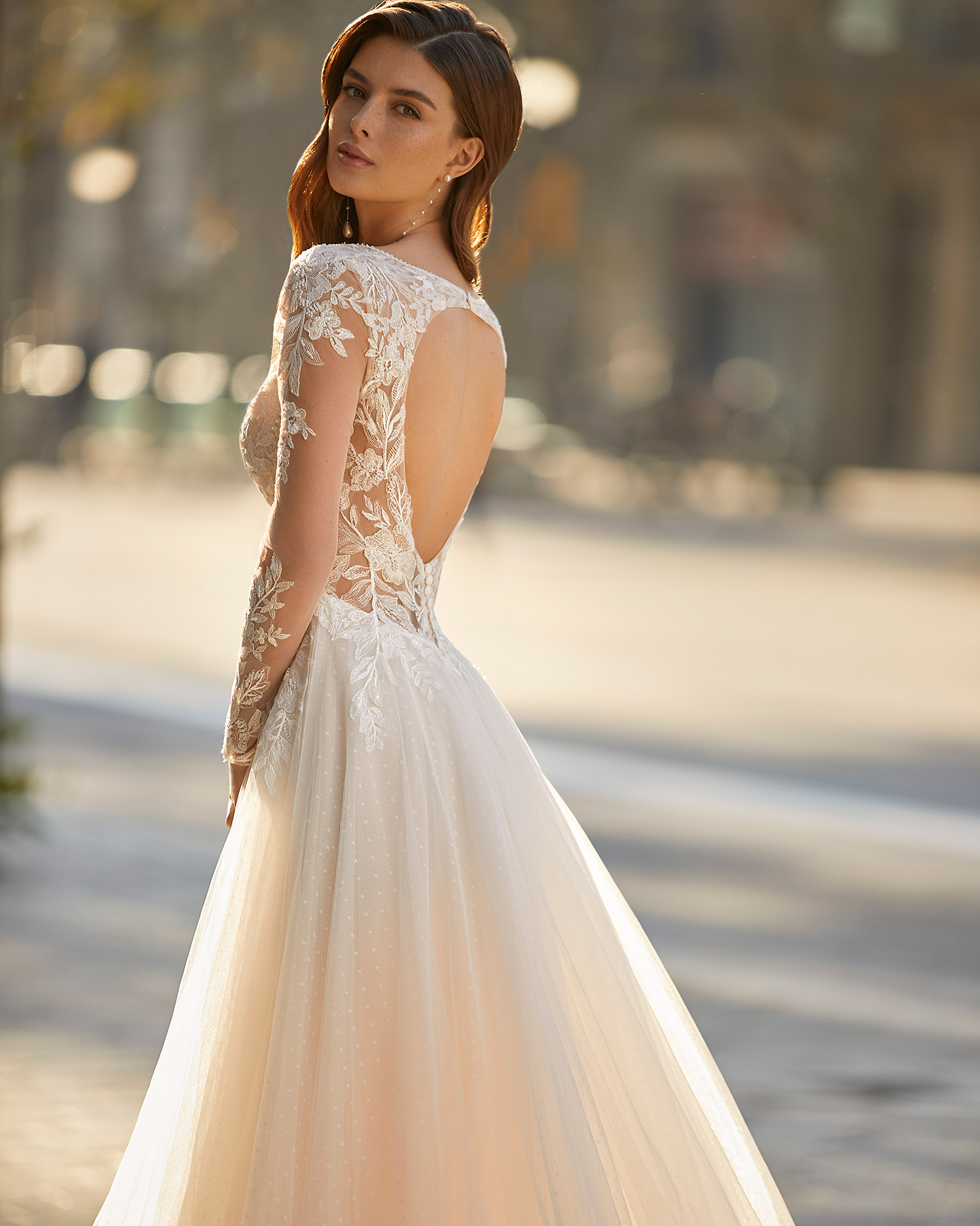 Romantic princess-style wedding dress, made of dot tulle and lace appliqués; with a deep-plunge neckline with beadwork detail, a back with a round slit, and long tulle and lace sleeves. Unique Luna Novias design made of dot tulle and lace with beadwork. LUNA_NOVIAS.