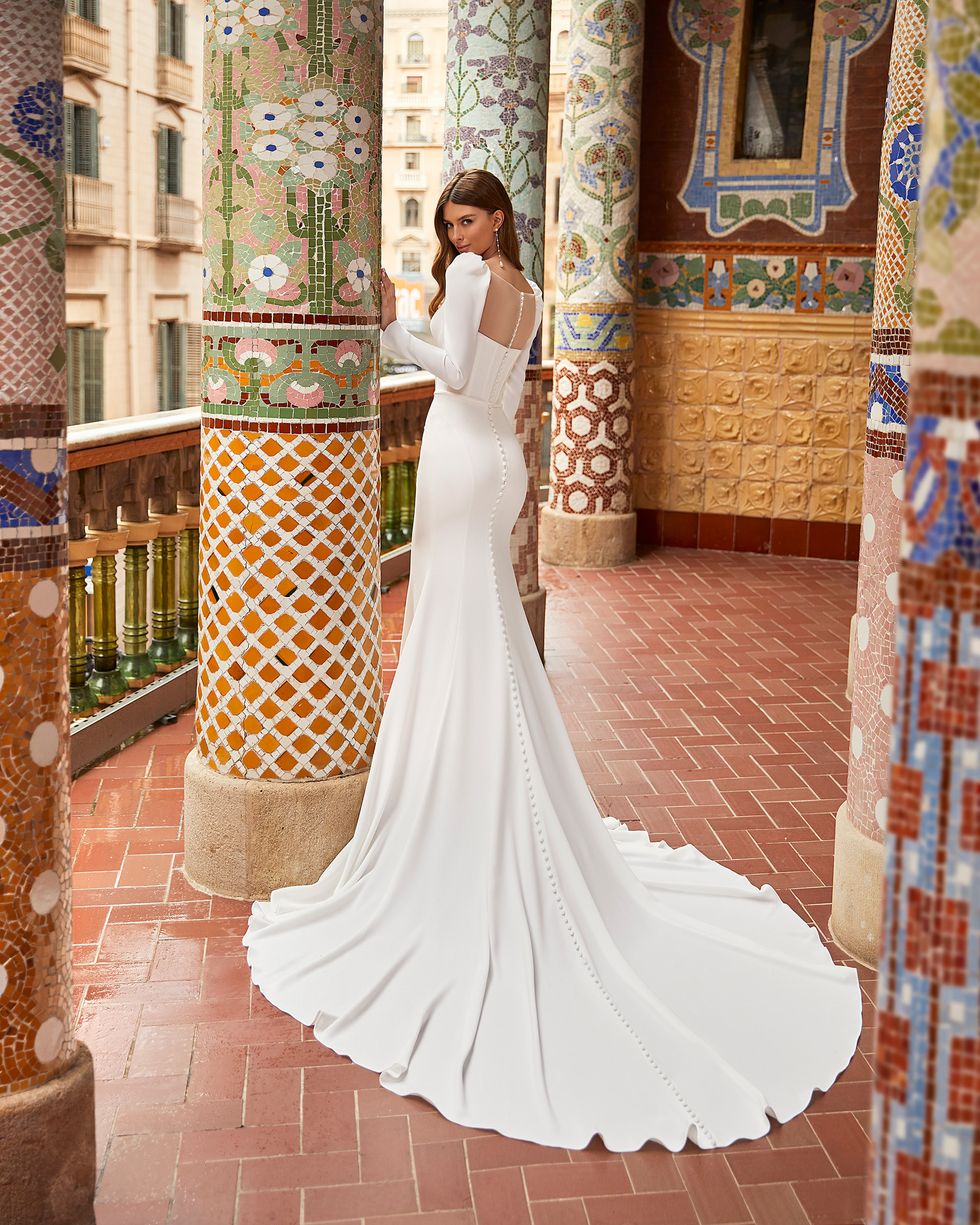 Modern sheath-style wedding dress, made of stretch crepe, featuring special sleeves; with a deep-plunge neckline, a button-up sheer back, and long sleeves. Trendy Luna Novias design entirely made of stretch crepe. LUNA_NOVIAS.