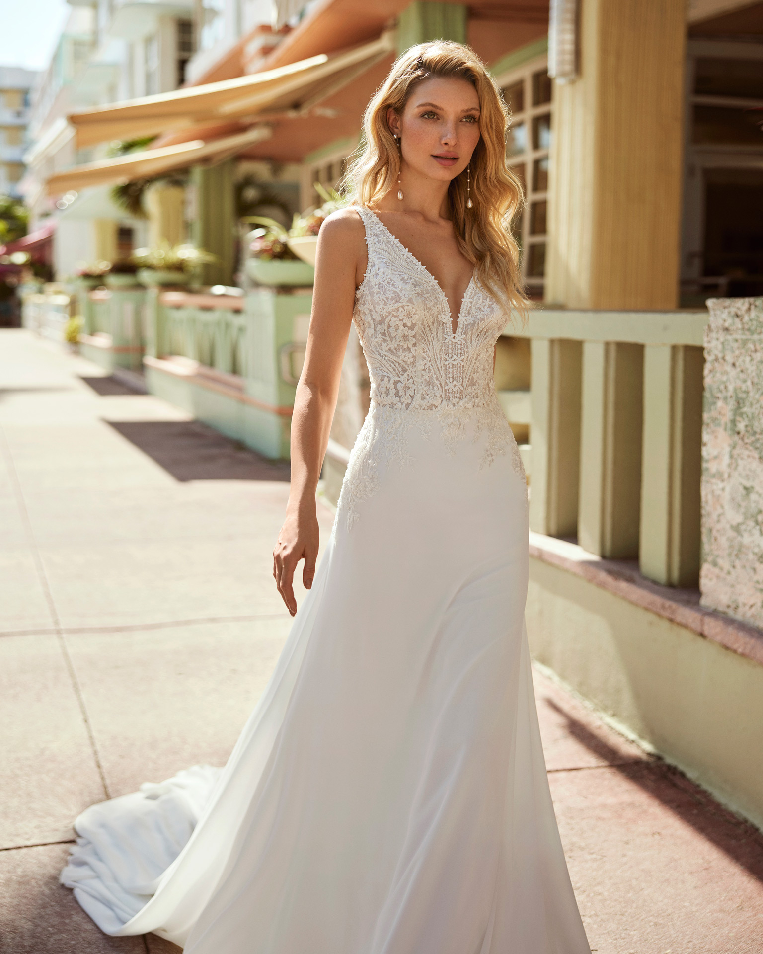 Fluid A-line wedding dress, crafted in georgette. Featuring a V-neckline, buttoned back, and straps. Show off this on-trend Luna Novias design. LUNA_NOVIAS.