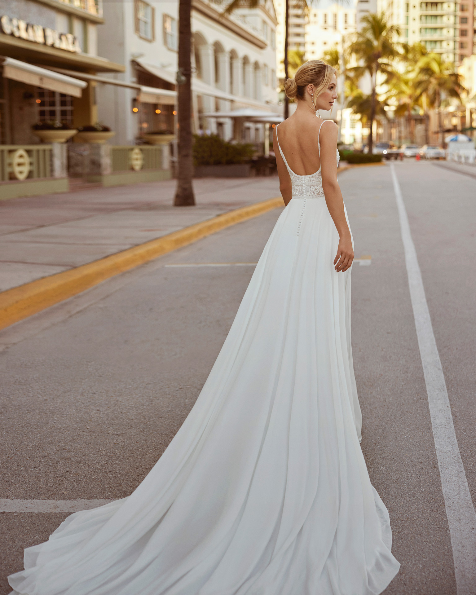 Princess-style A-line wedding dress, crafted in georgette. This Luna Novias dress is guaranteed to leave you captivated, with its round neckline and open back with straps. LUNA_NOVIAS.