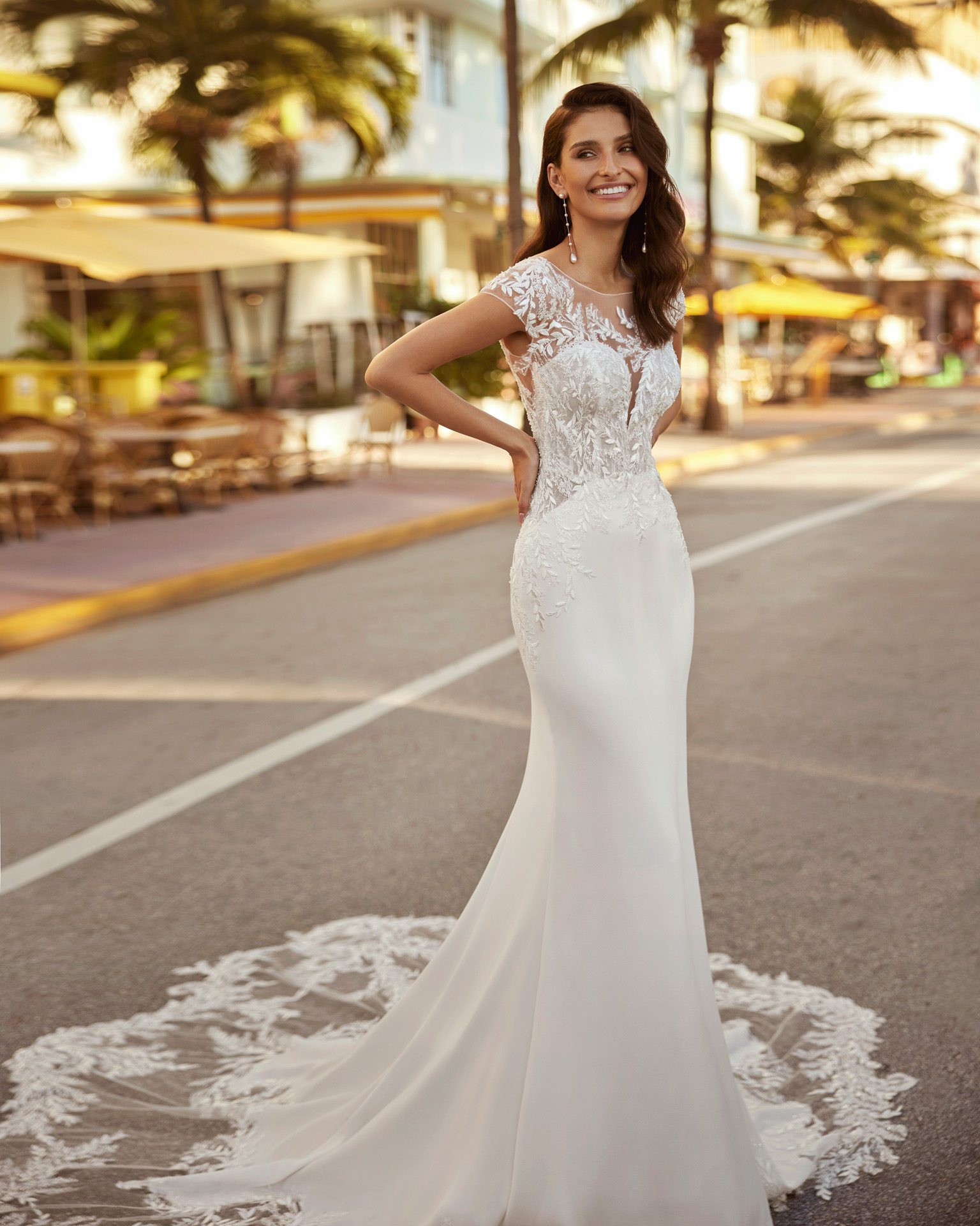 Sexy mermaid wedding dress, made in crepe combined with lace. This delicate Luna Novias design features a V-neckline, open back and short sleeves. LUNA_NOVIAS.