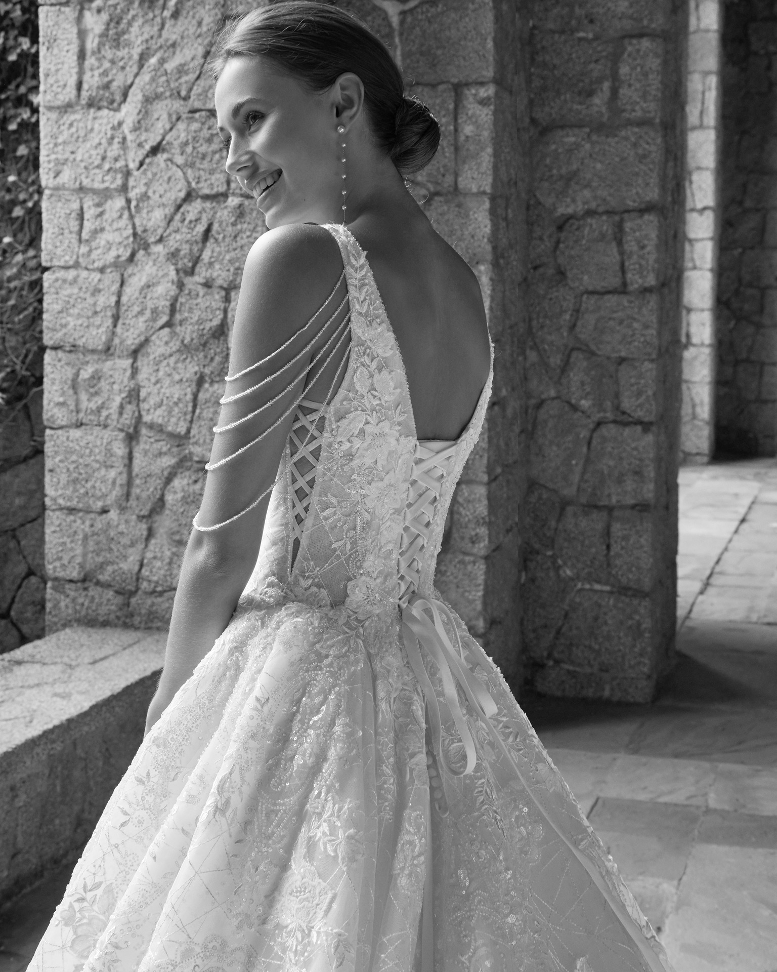 Romantic princess wedding dress, crafted in lace and beadwork. This dreamy Luna Studio gown features a plunging neckline, corset back and beadwork straps. LUNA_NOVIAS.