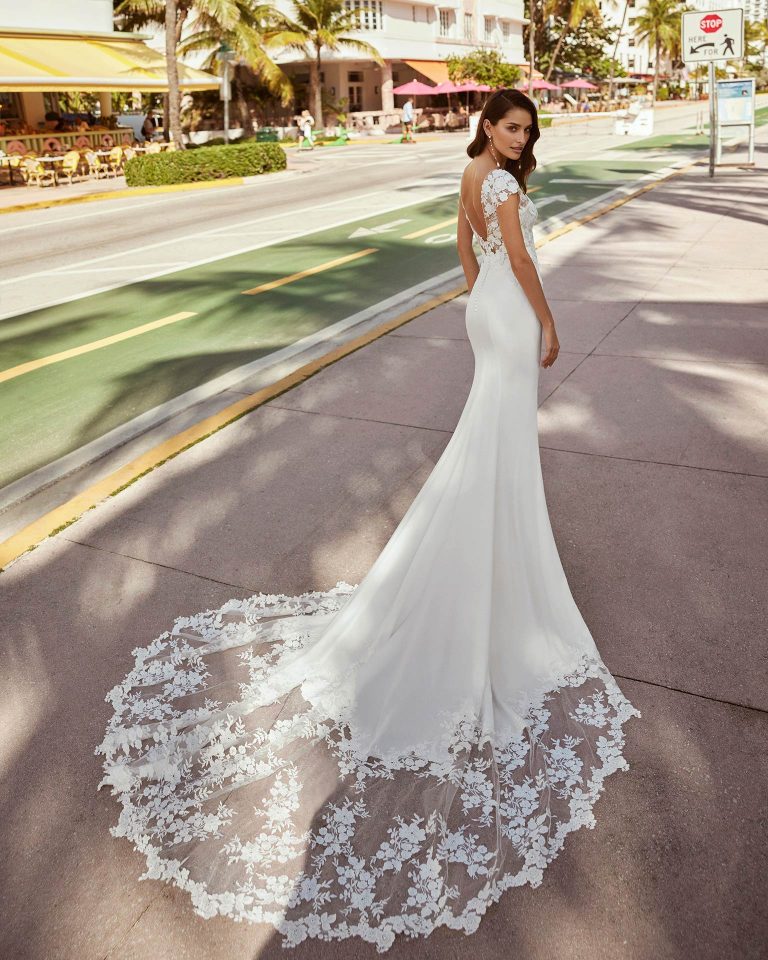 Romantic mermaid wedding dress, made in crepe combined with lace. This dreamy Luna Novias design features a V-neckline, open back and short sleeves. LUNA_NOVIAS.