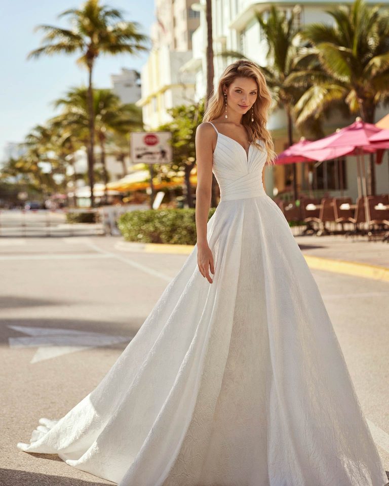 Elegant princess wedding dress, crafted in brocade Nature. It doesn't get more graceful than this delicate Luna Novias design featuring a V-neckline, V-back, straps, and maxi-volume skirt. LUNA_NOVIAS.